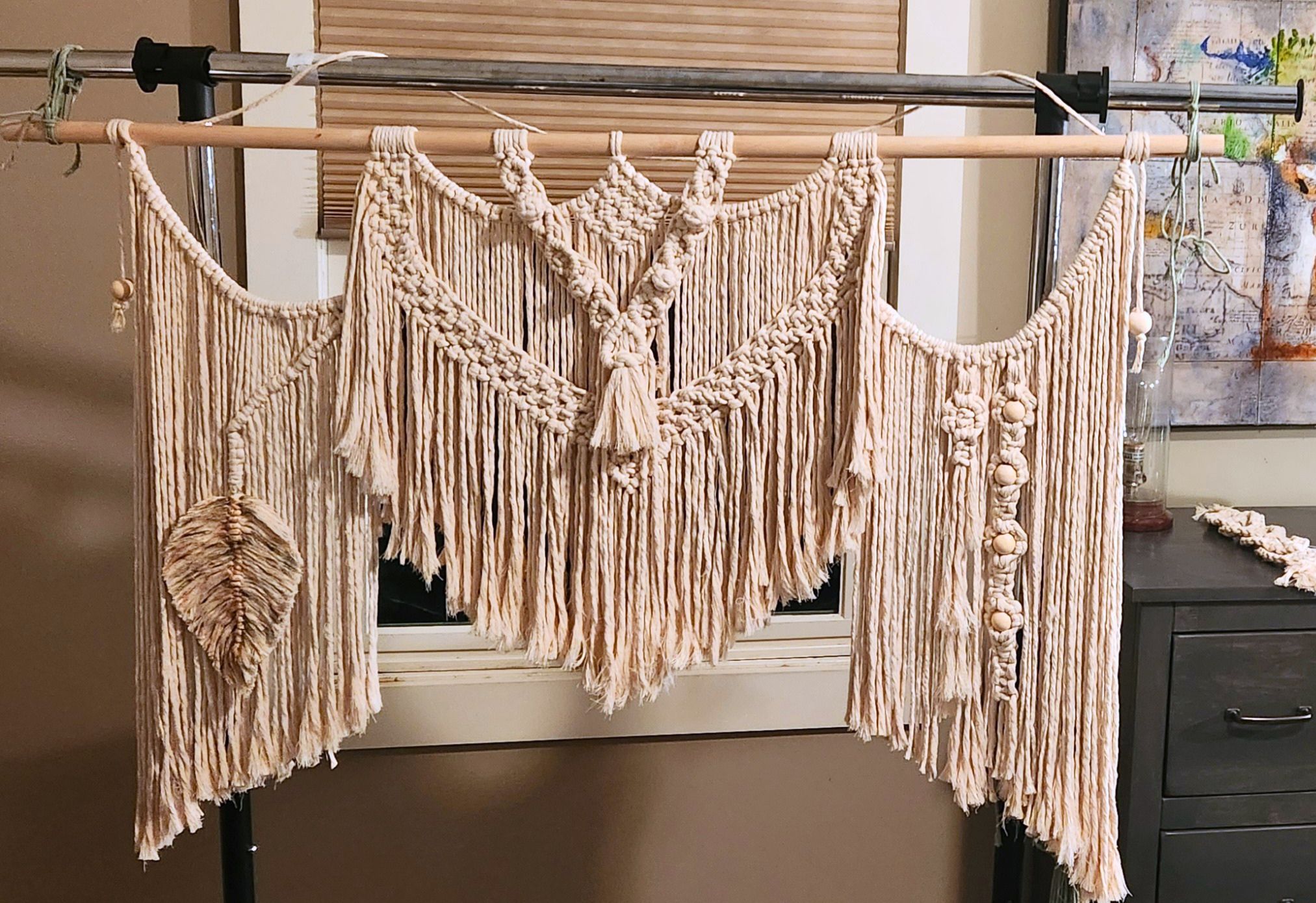 Finished macrame wall hanging in a student's home